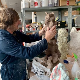 Dean Coates in his studio working on a sculpture