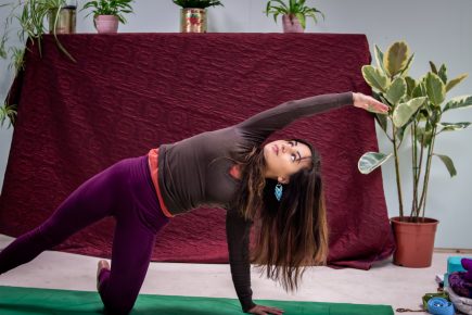 Yoga instructor holding a pose during a vinyasa flow yoga class at St Anne's House