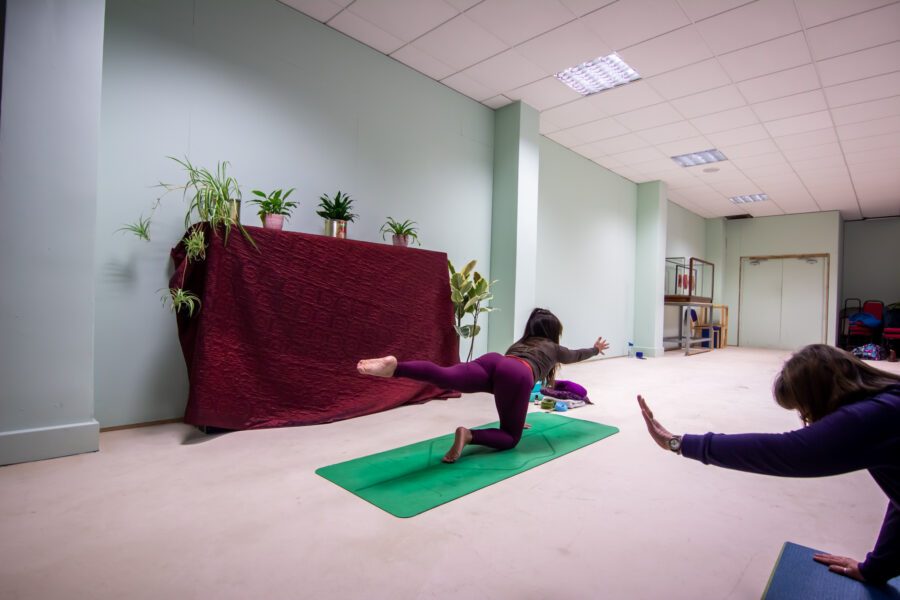 A woman teaching yoga at St Anne's House