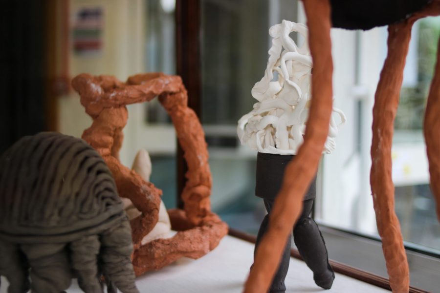 A close up of burnt orange, brown and white sculptures in the Curio vitrine by Sam Lucas.