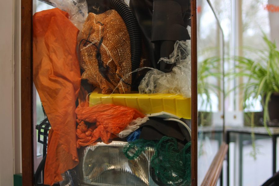 A shot of Curio with Ben Hartley's artwork inside. A vitrine full of plastic bags, string, and things found on the streets of Bristol. It's jammed full.