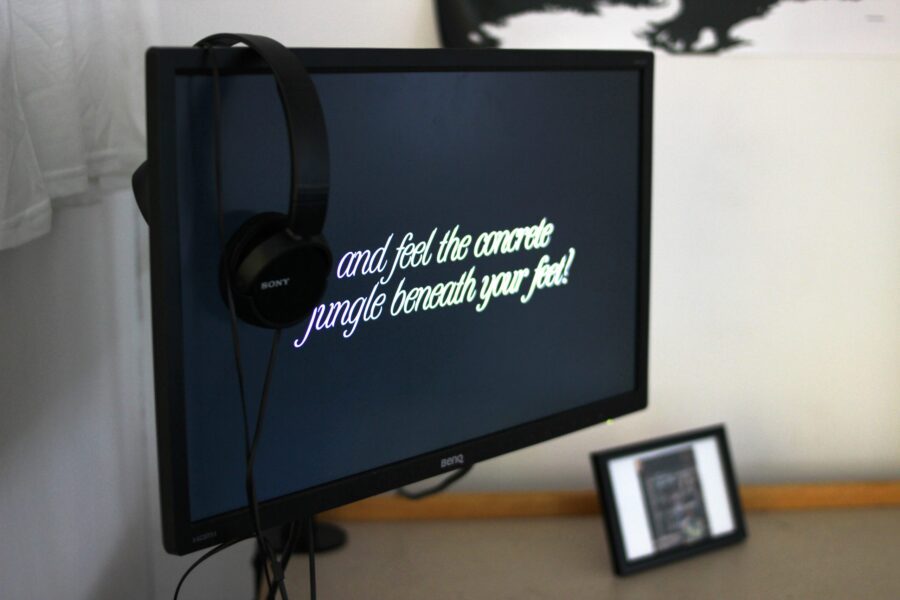 A computer screen with an artwork for Confine + Escape. The text reads: and feel the concrete jungle beneath your feet?