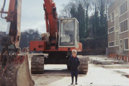 A child stood infront of digger taken in 1983 outside St Anne's House.