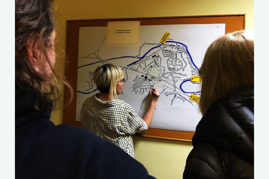 A person drawing on a map in St Anne's House