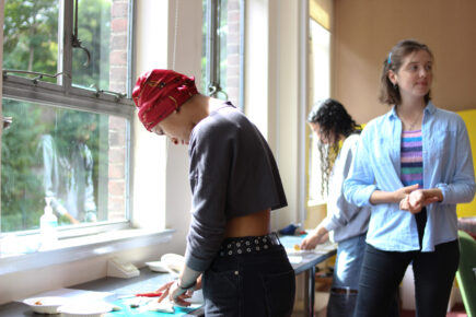 Three young people taking part in a workshop making food