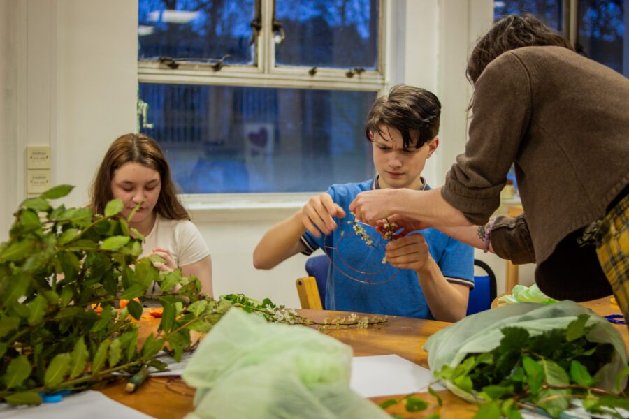 Two young people making wreaths at a workshop session at St Anne's House.