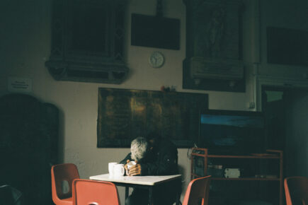 A homeless man falls asleep, after receiving a hot drink at the drop-in centre St Hilda's church, South Shields, September 2023.