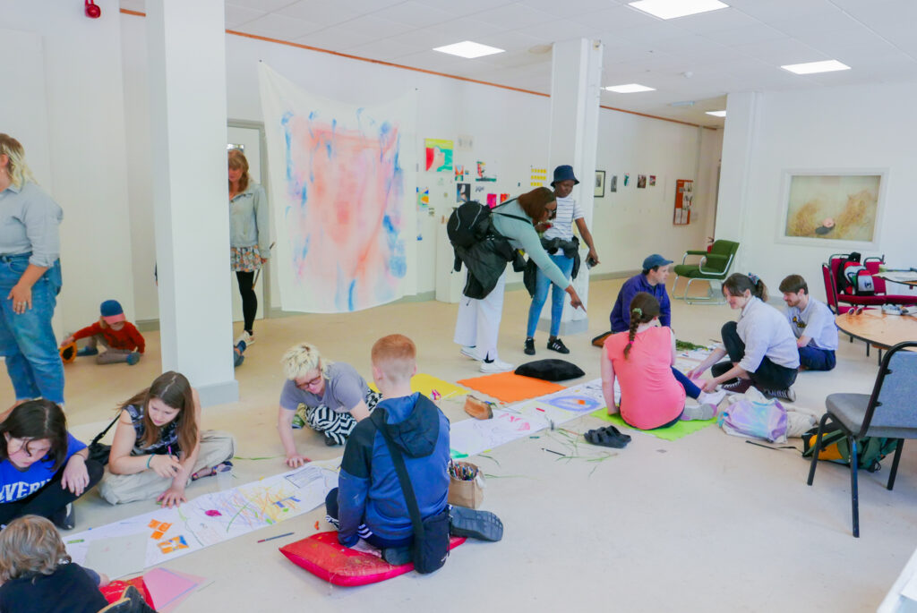 A group of people taking part in an art workshop at St Anne's House 